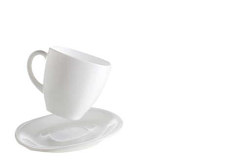 White flying cup and saucers on an isolated background.