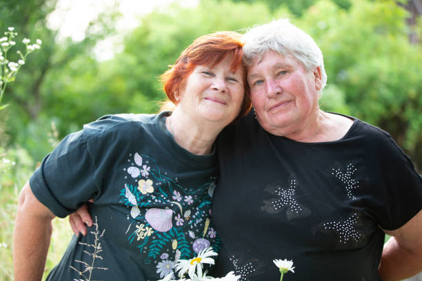 istock Two older women friends hugging and looking at the camera. 1340555525