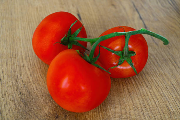 istock close-up on a branch of fresh tomatoes. 1340555833