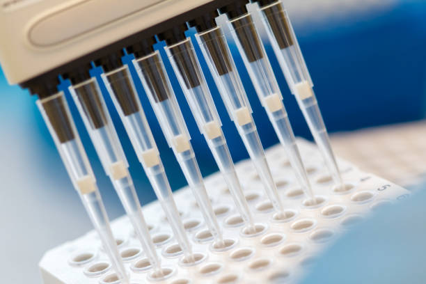 istock Research scientist pipetting SARS_CoV-2 samples to a plate using a multichannel pipette 1340556400