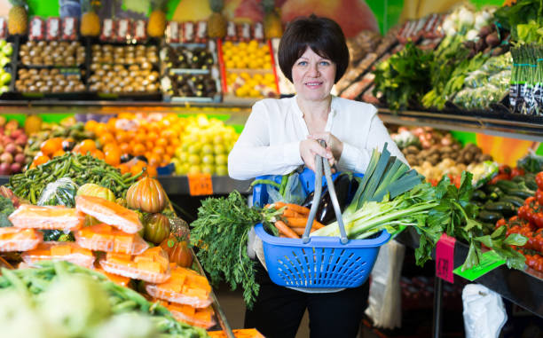 istock Mature woman buying fresh vegetables 1340557332