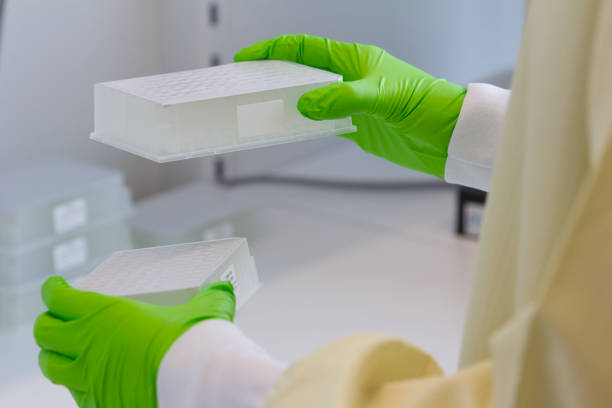 istock Scientist transferring deep-well plates to centrifuge 1340557611