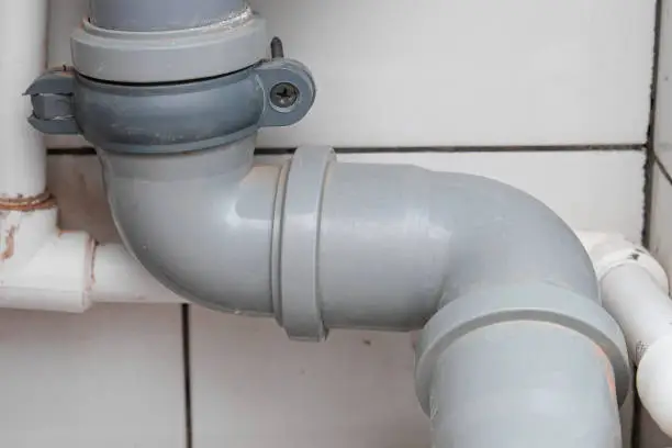 Sewer pipes in home, connection of grey polipropilen pipes for wash basin, washbowl drain.