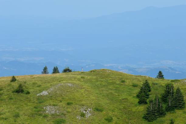 istock a man on a hill in the mountains 1340560210