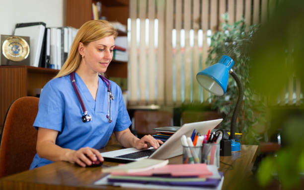 istock Woman doctor sitting at workplace with computer in office 1340560491