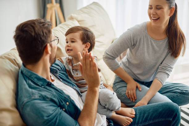 istock Young parents having fun with their small son at home. 1340560539