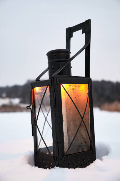 istock Old candle lantern in the snow 1340560673