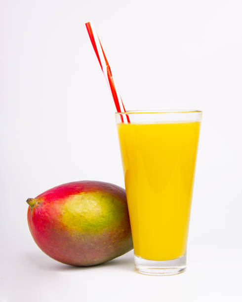 istock Tropical mango exotic fruit and juice in glass on the white 1340566979