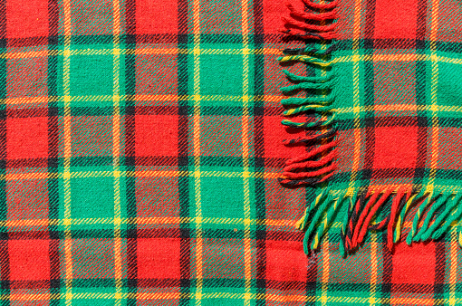 Traditionalscottish  woolen textile with checked green and red pattern