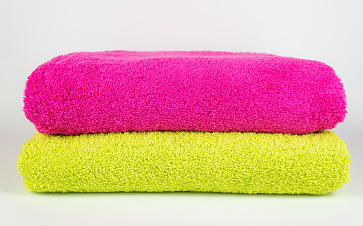 Pink and light green towel on white background