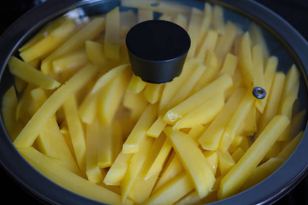 istock Beautiful yellow potato sliced in a frying pan. 1340568986