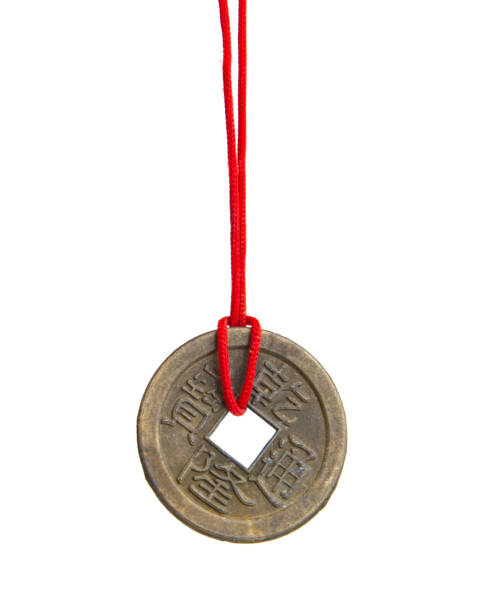 Old chinese coin fortune traditional with red rope isolated on the white background Old chinese coin fortune traditional with red rope isolated on the white background chinese yuan coin stock pictures, royalty-free photos & images