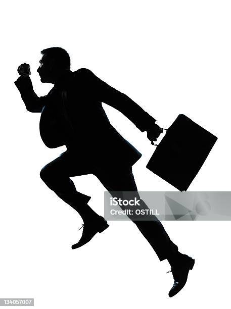 Un Uomo Daffari Salto In Esecuzione Sagoma - Fotografie stock e altre immagini di 35-39 anni - 35-39 anni, Completo, Corsa veloce