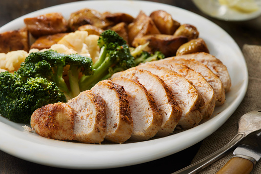 Seasoned Chicken Breast with Roasted Potatoes and Steamed Broccoli and Cauliflower