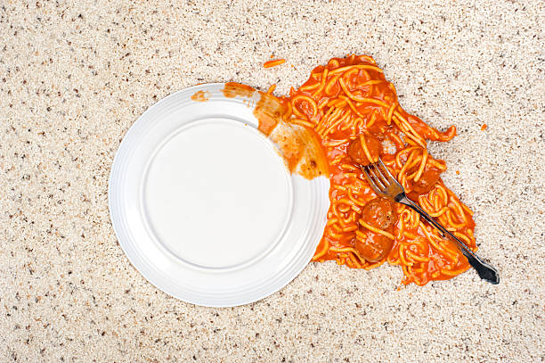 Dropped plate of spaghetti on carpet A dropped plate of spaghetti on new carpeting. spilling photos stock pictures, royalty-free photos & images