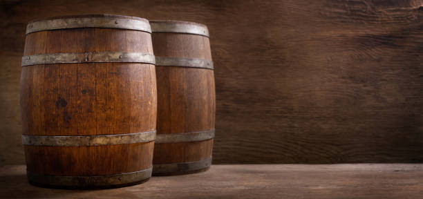 istock Old wooden barrels in a warehouse 1340570898