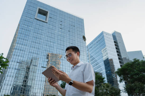 istock An Asian white-collar man uses a tablet computer in a modern city 1340572343
