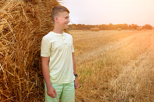 Teenager in a wheat field on a sunny day. Children in nature