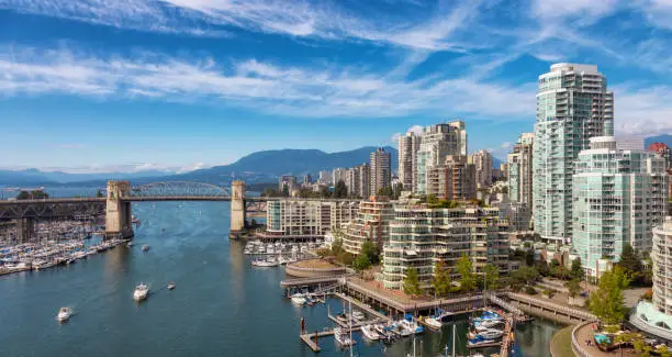 View of Burrard Bridge and False Creek in Downtown Vancouver, British Columbia, Canada. Modern City on the West Coast of Pacific Ocean. Sunny summer day.