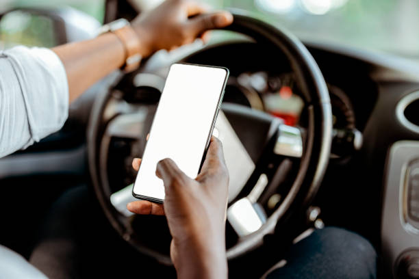 istock Mockup of a man using a mobile smartphone inside a car 1340575180