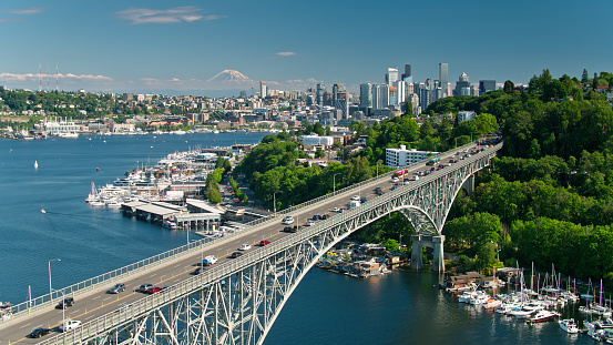 Aerial shot of Seattle, Washington on a sunny day in summer. The Aurora Bridge and the Fremont Bridge carry traffic between Queen Anne and Fremont across the Lake Washington Ship Canal as it opens up into Lake Union.