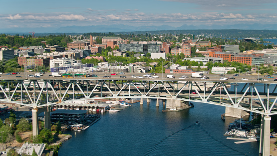 Aerial shot of Seattle, Washington on a sunny day in summer, looking towards the University District with Lake Washington beyond and the Ship Canal Bridge connecting it to the Capitol Hill neighborhood.