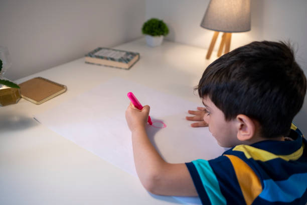 istock Adorable little boy, drawing picture 1340576432
