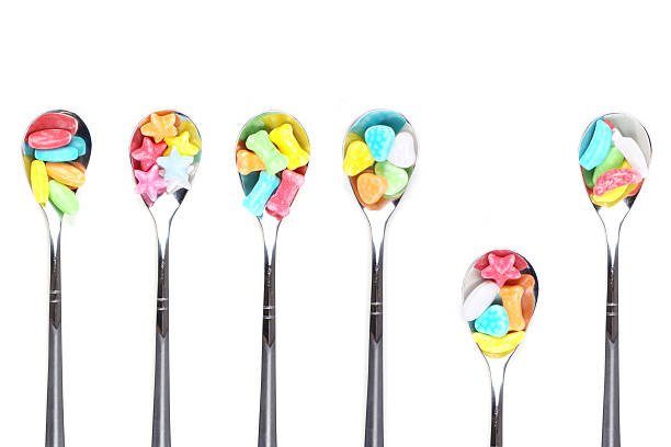 istock colorful candy with metal spoons 134057743