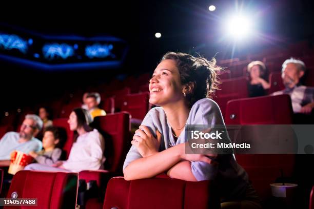 Girl Enjoying Watching A Nice Movie At The Cinema Stock Photo - Download Image Now - Movie Theater, Movie, Film Industry