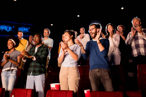 istock Satisfied audience applauding after a film reel 1340577521