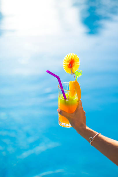 istock A COCKTAIL IN HAND BY THE POOL 1340584741