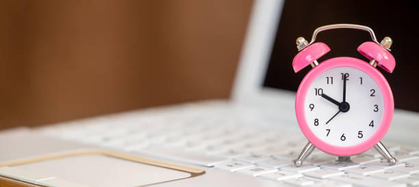 istock Clock on a laptop, time management, save time banner 1340584835