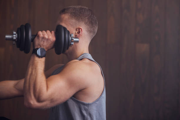 istock Handsome Blond Man Exercising at the Gym 1340585502