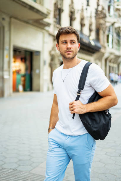istock Young man with backpack in city 1340587150