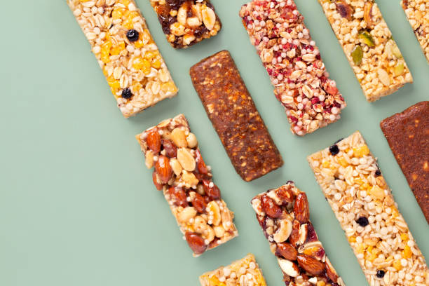 Granola bars.  Muesli. Healthy energy bars made of cereals, berries, nuts and fruits on a light green background. Space for the text. Copy space. Top view. Granola bars.  Muesli. Healthy energy bars made of cereals, berries, nuts and fruits on a light green background. Space for the text. Copy space. Top view. granola stock pictures, royalty-free photos & images