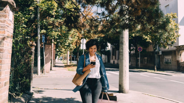Beautiful Woman Using Mobile Phone in City