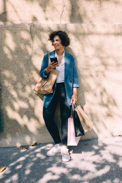 istock Beautiful Woman Using Mobile Phone in City 1340589277