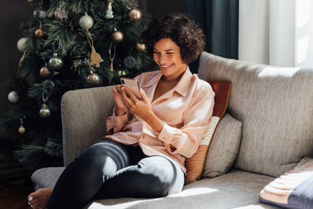 istock Beautiful Woman Using Mobile Phone at Home 1340589296