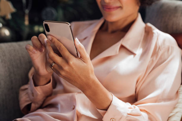 istock An Anonymous Woman Using Mobile Phone at Home 1340589299