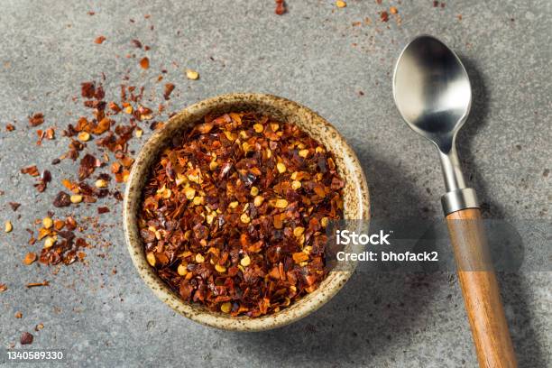Organic Raw Red Pepper Flakes Stock Photo - Download Image Now - Red Bell Pepper, Crushed, Red
