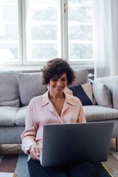 istock Beautiful Woman Working on Laptop Computer at Home 1340589336