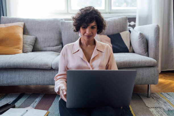 istock Beautiful Woman Working on Laptop Computer at Home 1340589338