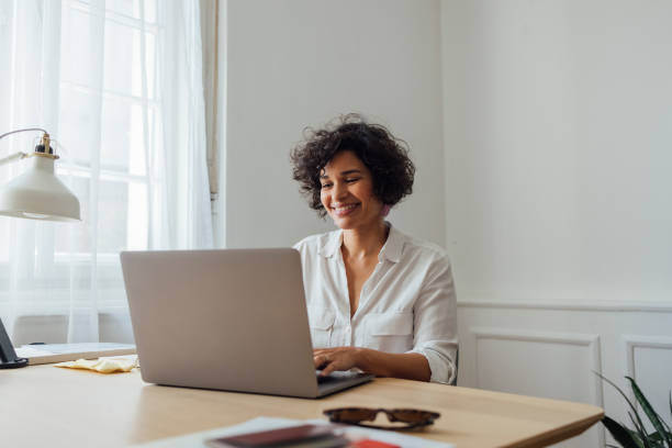 istock Beautiful Woman Working on Laptop Computer at Home 1340589359