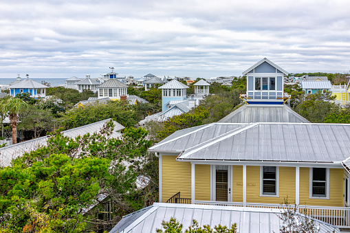 High angle aerial view on Gulf of Mexico sea ocean water in Seaside, Florida and cityscape of terrace buildings houses from balcony in winter