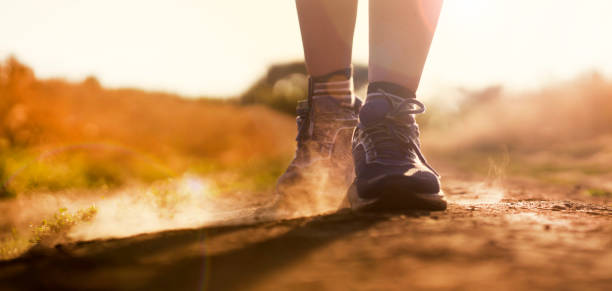 istock Female athletic legs and dust from the trail close up. 1340591507