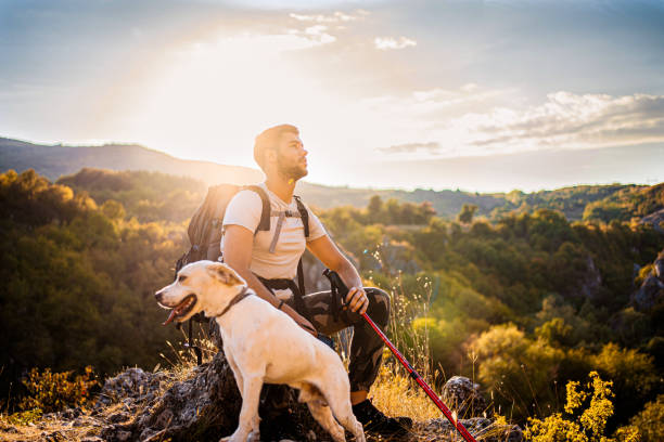istock Man with his best friend taking a break from hiking 1340591717