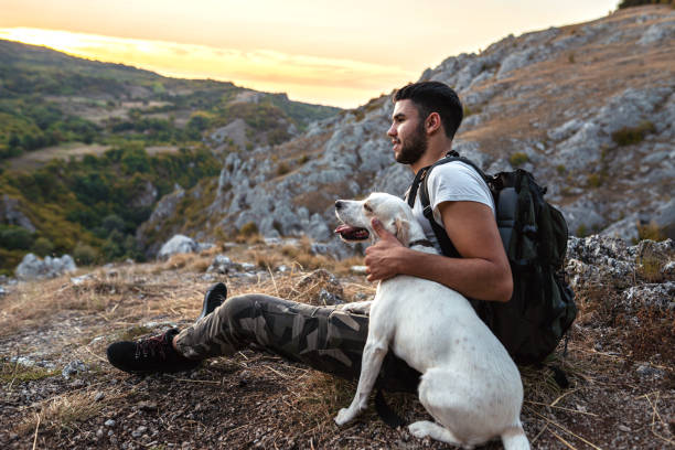 istock Man with his best friend taking a break from hiking 1340592343