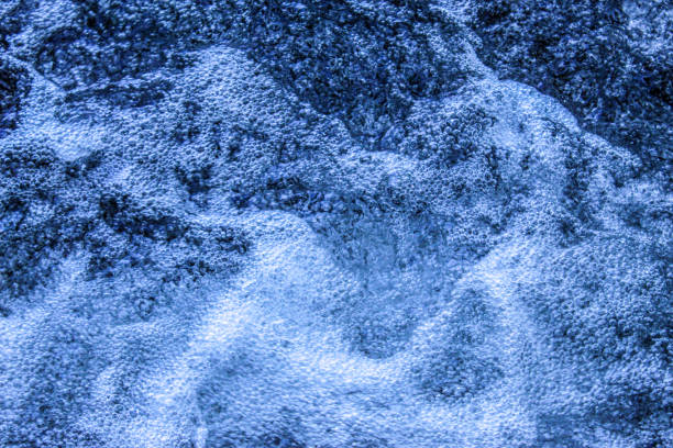 istock Blue water background. White foam on blue water. 1340592381