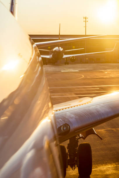 istock Airplane at sunset on the runway. 1340592418
