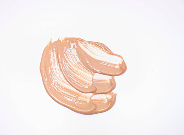 istock liquid tonal cream smear. Light brown makeup concealer stain isolated on white background. 1340592512